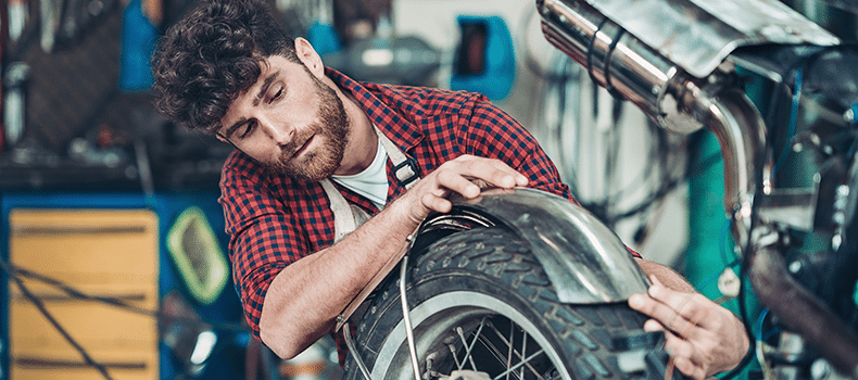 man preparing his motorcycle for shipping