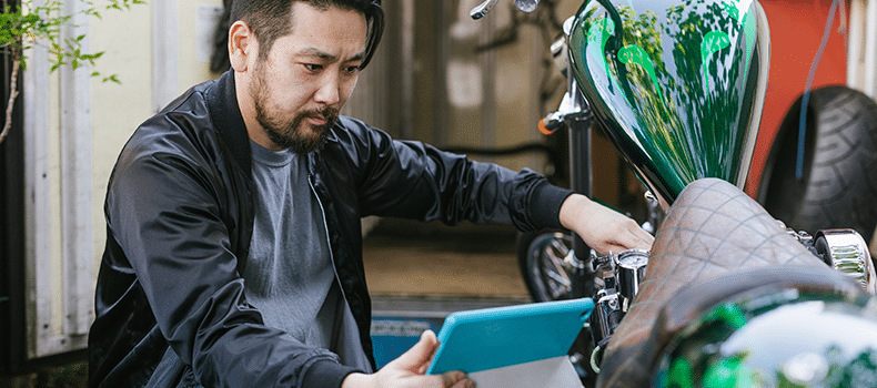 motorcycle driver comparing insurance options